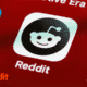 Close-up of the Reddit app icon on a smartphone screen, representing a marketing strategy for boosting SaaS visibility with Reddit upvotes and discussions.
