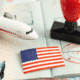 A collection of U.S. immigration symbols, including an airplane, American flag, and visa stamps, illustrating a guide to classifieds websites for housing rentals and job searches in the U.S.