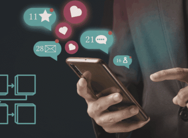 A person using a smartphone with floating social media engagement icons and an automated workflow diagram, representing AI social media workflows in 2026 for lean teams.