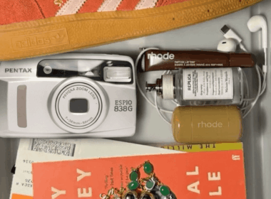 A lifestyle flat lay featuring a Pentax Espio 838G compact camera, representing the comeback of compact cameras and a digital detox lifestyle.