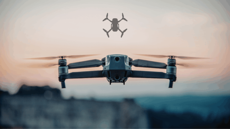 A high-performance FPV drone hovering over a mountain landscape at sunset, illustrating the revolution of First-Person View technology changing the skies.