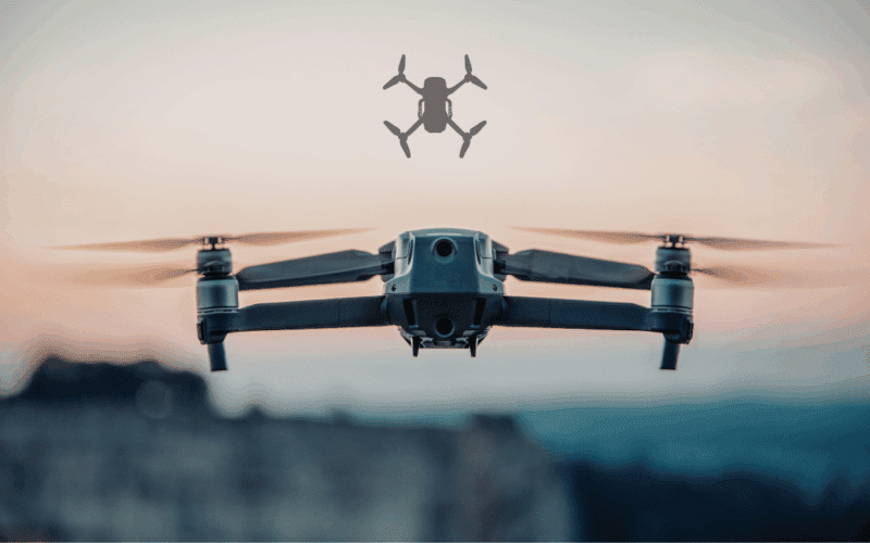 A high-performance FPV drone hovering over a mountain landscape at sunset, illustrating the revolution of First-Person View technology changing the skies.
