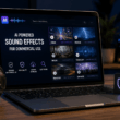 Laptop showing an AI sound effects marketplace with audio waveforms, sound categories, headphones and a microphone for commercial sound design.